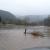 Nelson Mountain Road on south side of bridge.  Lake Creek over it's banks